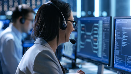 Female working at a help desk as a service company on a computer