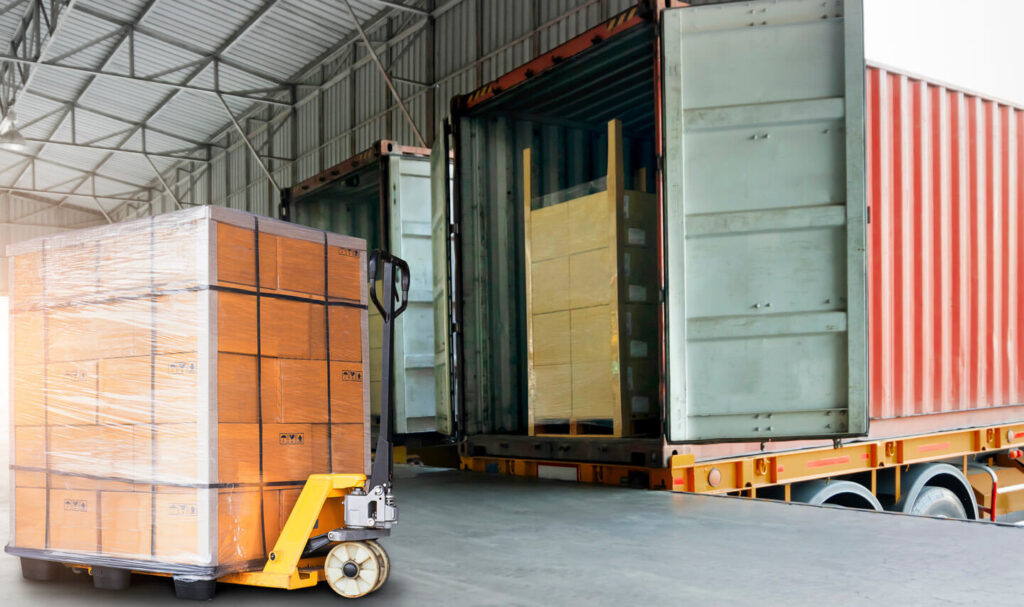 A forklift transports boxes into a warehouse as part of a post-disaster shelter supply chain operation.